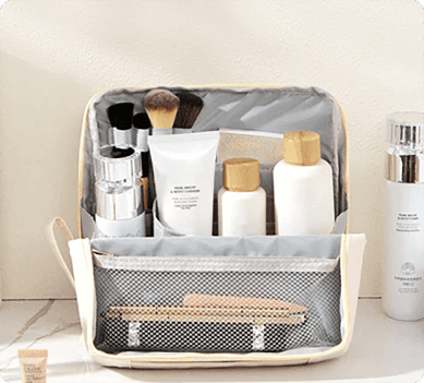 Open ivory organizer filled with bottles, brushes and makeup